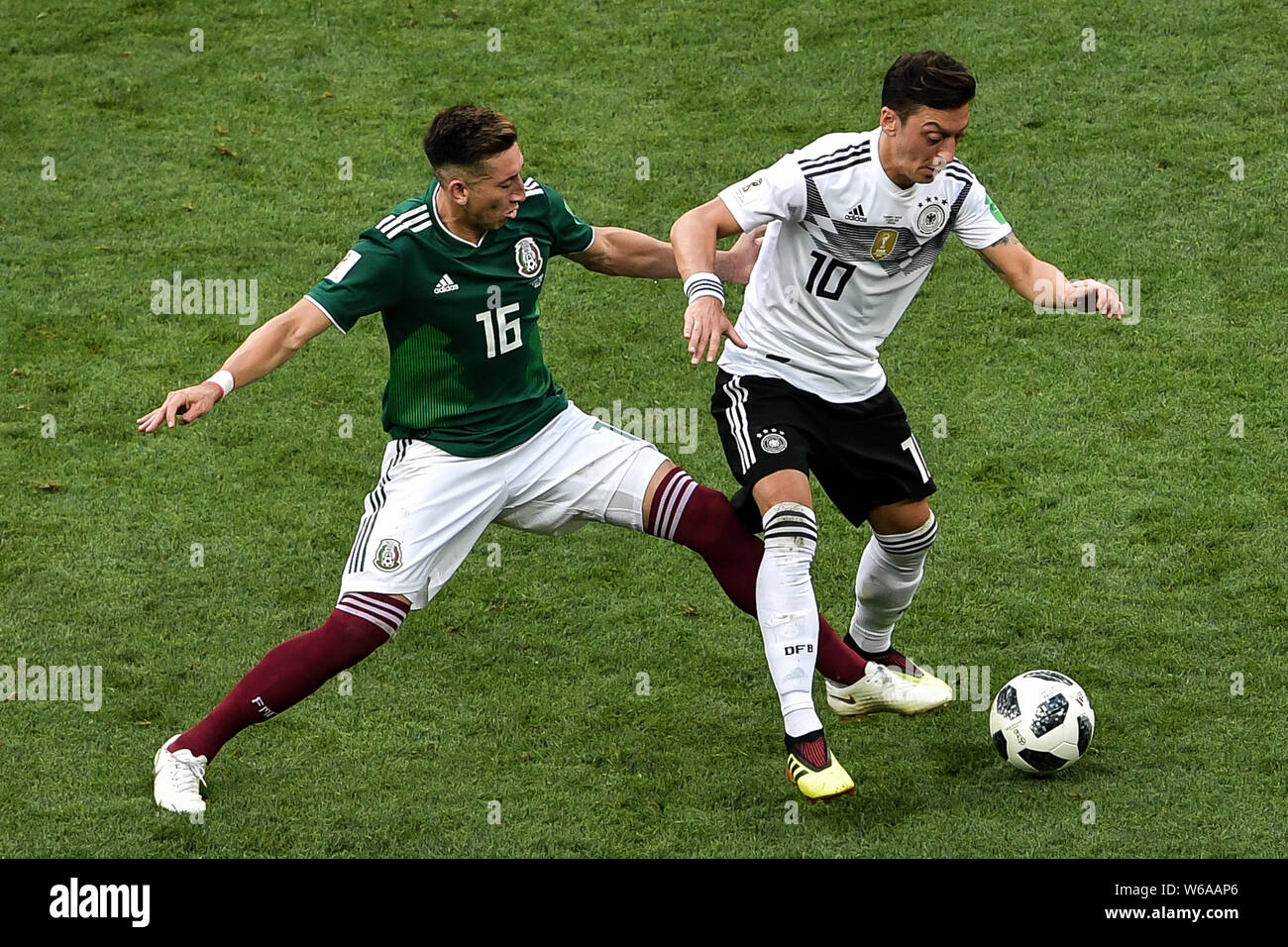 Hector Herrera of Mexico, left, challenges Mesut Oezil (Ozil) of Germany in their Group F match during the FIFA World Cup 2018 in Moscow, Russia, 17 J Stock Photo