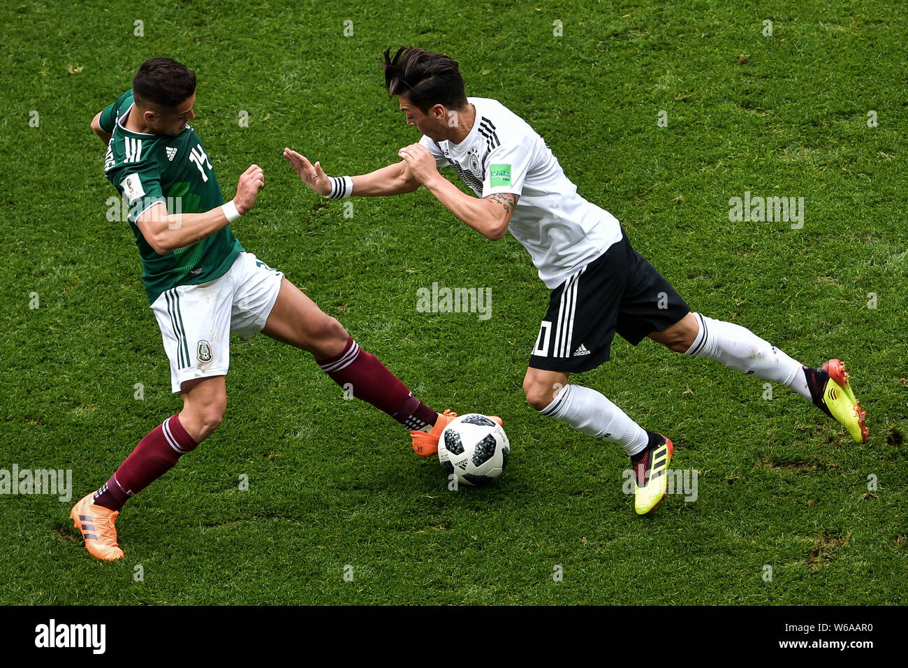 Javier Hernandez of Mexico, left, challenges Mesut Oezil (Ozil) of Germany in their Group F match during the FIFA World Cup 2018 in Moscow, Russia, 17 Stock Photo