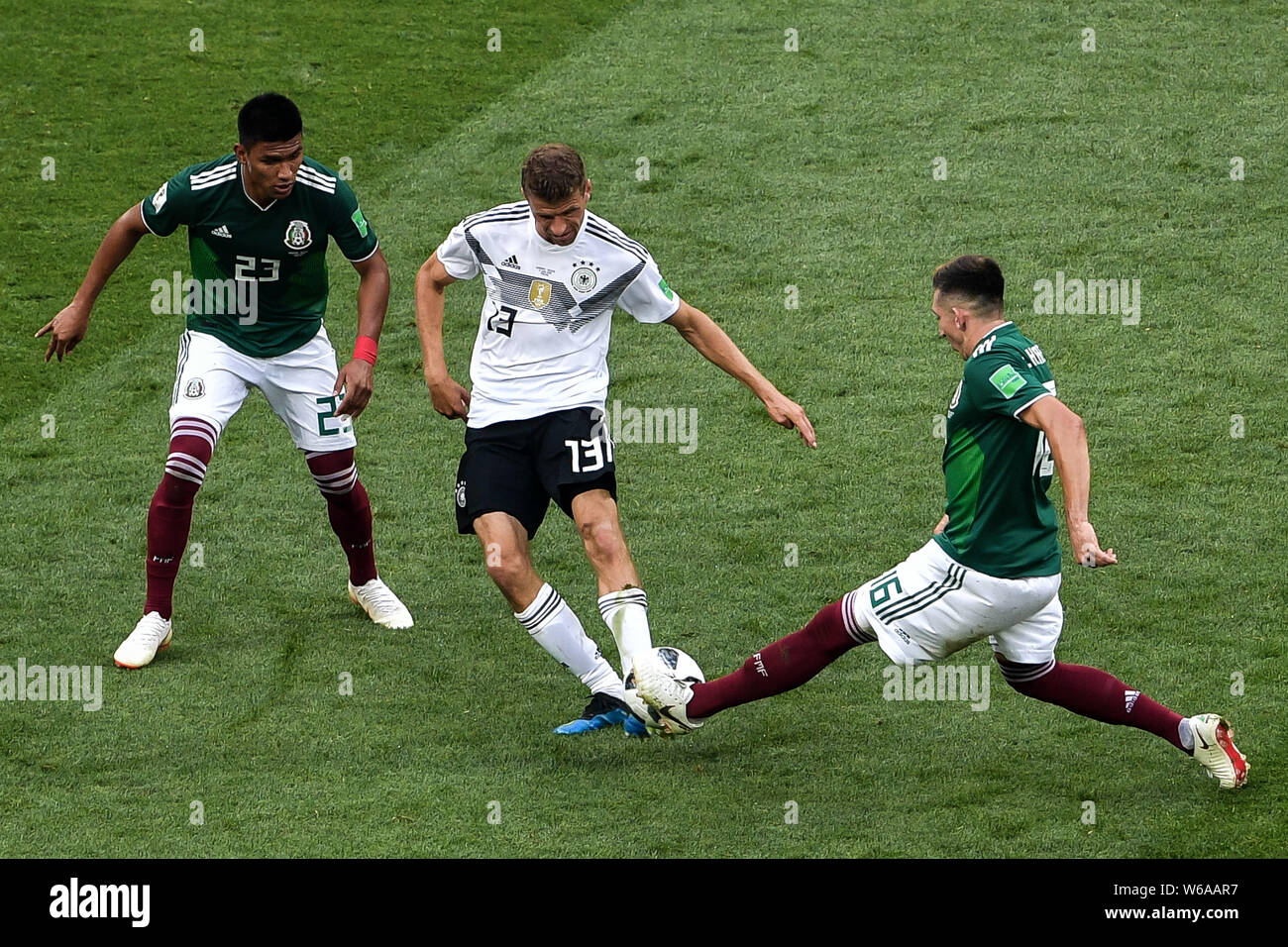 Thomas Mueller (Muller) of Germany, center, challenges Hector Herrera, right, and Jesus Gallardo of Mexico in their Group F match during the FIFA Worl Stock Photo