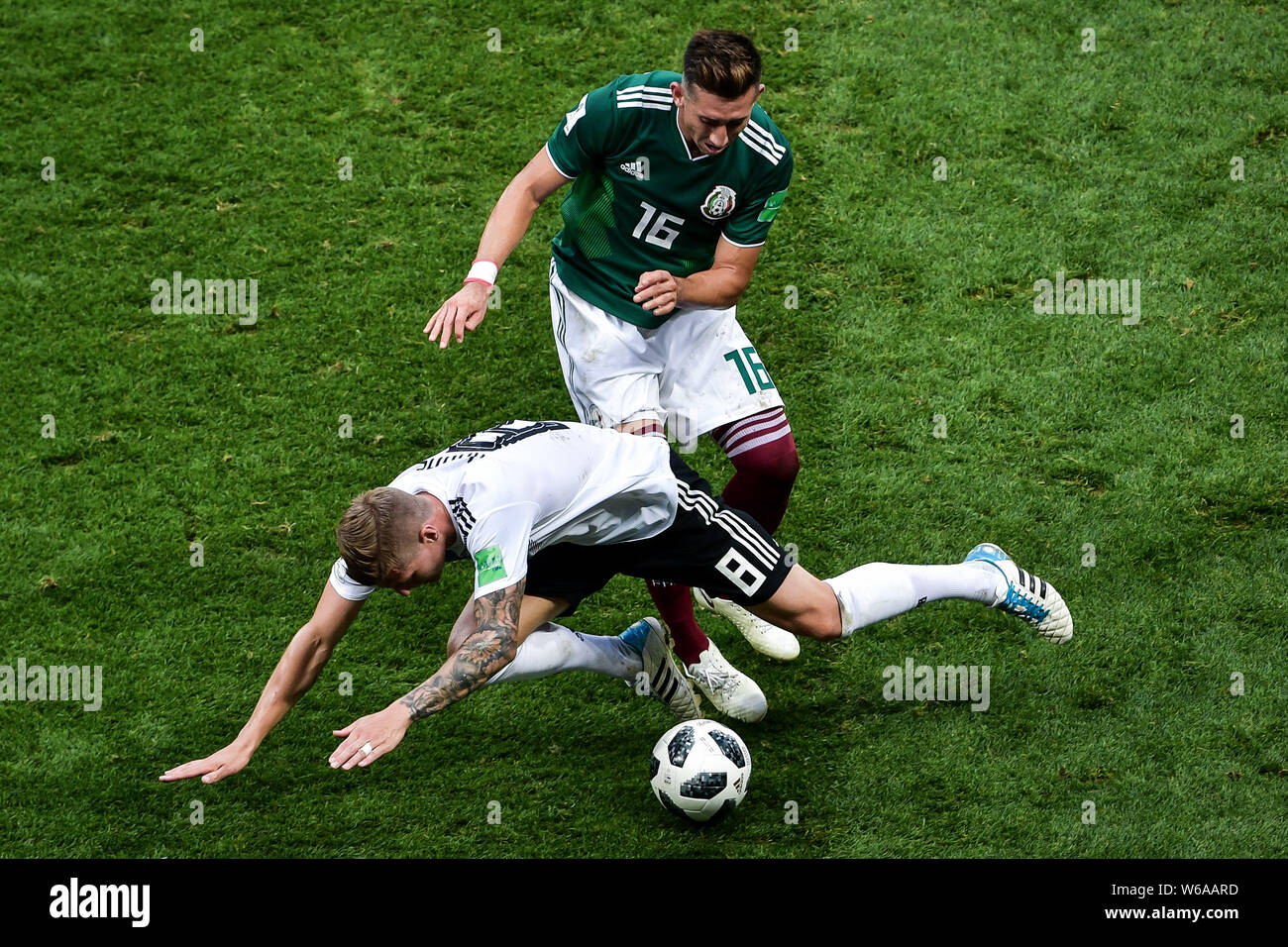 Hector Herrera of Mexico, back, challenges Toni Kroos of Germany in their Group F match during the FIFA World Cup 2018 in Moscow, Russia, 17 June 2018 Stock Photo