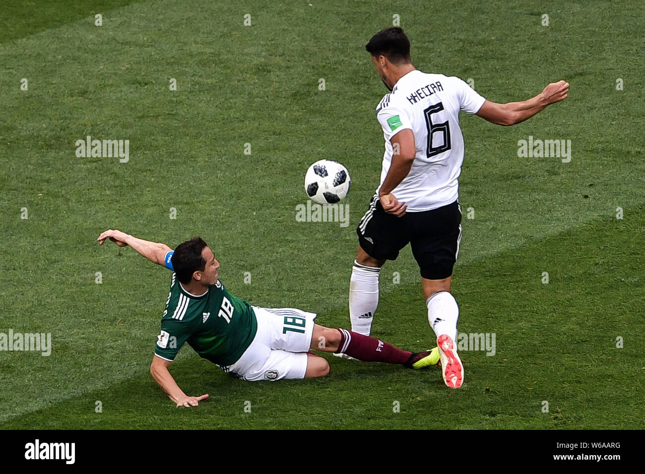 Andres Guardado of Mexico, bottom, slide-tackles Sami Khedira of Germany in their Group F match during the FIFA World Cup 2018 in Moscow, Russia, 17 J Stock Photo