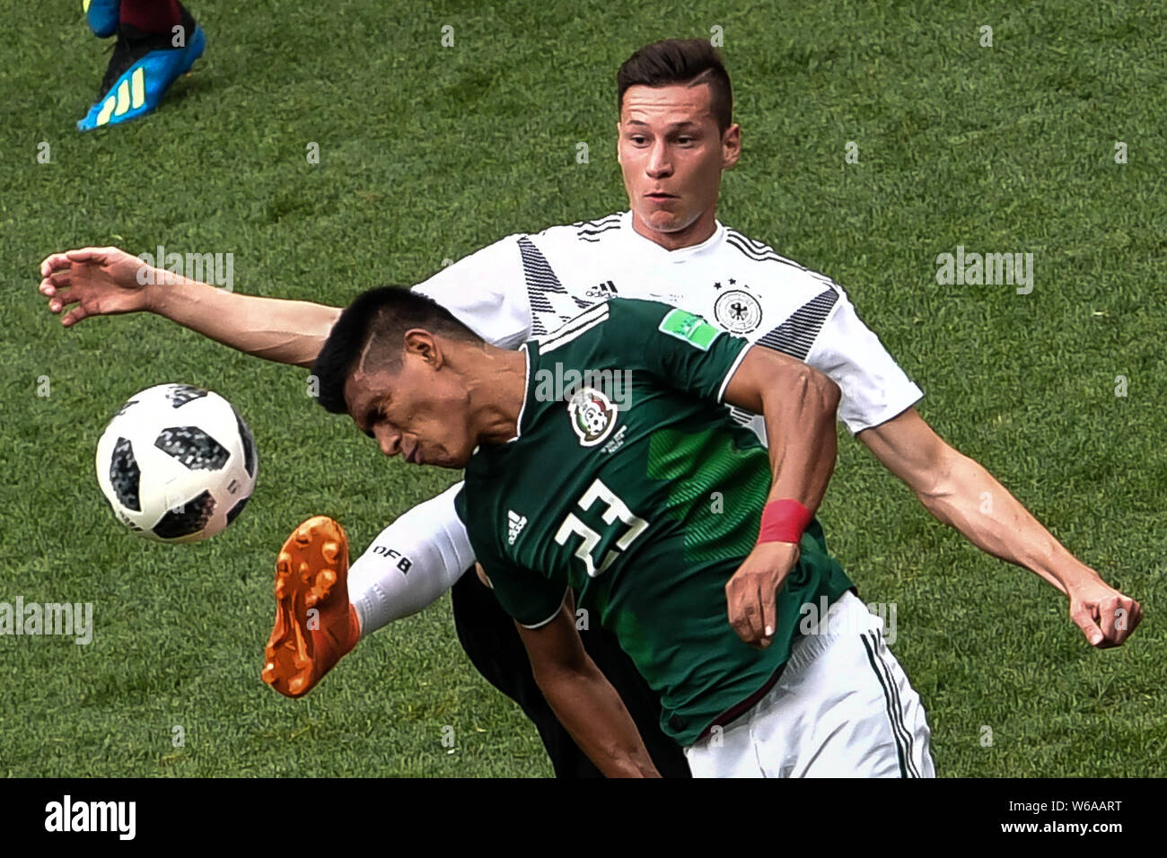 Jesus Gallardo of Mexico, front, challenges Julian Draxler of Germany in their Group F match during the FIFA World Cup 2018 in Moscow, Russia, 17 June Stock Photo