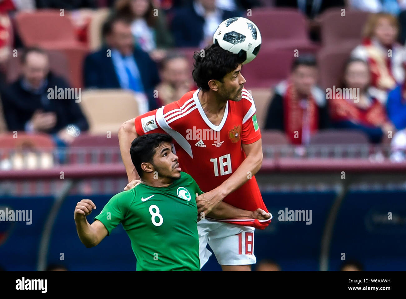 Yuri Zhirkov of Russia, right, heads the ball against Yahya Al-Shehri of Saudi Arabia in their Group A match during the 2018 FIFA World Cup in Moscow, Stock Photo