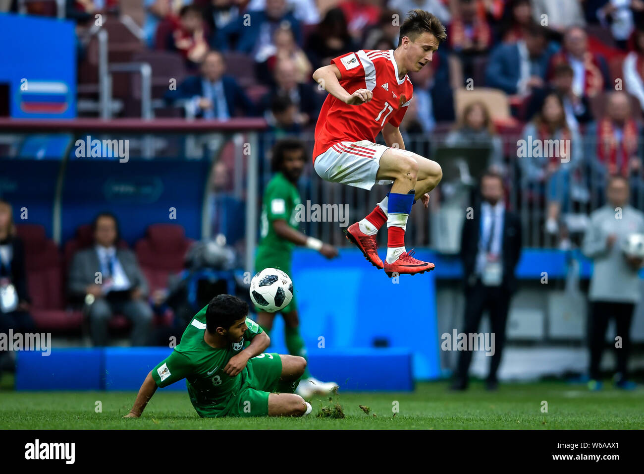 Aleksandr Golovin of Russia, right, challenges Yahya Al-Shehri of Saudi Arabia in their Group A match during the 2018 FIFA World Cup in Moscow, Russia Stock Photo