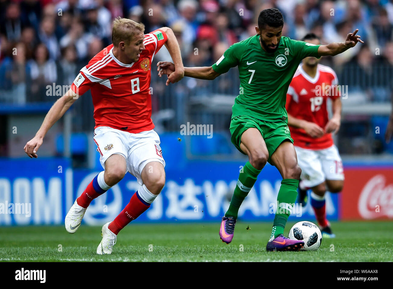 Yury Gazinsky of Russia, left, challenges Salman Al-Faraj of Saudi Arabia in their Group A match during the 2018 FIFA World Cup in Moscow, Russia, 14 Stock Photo