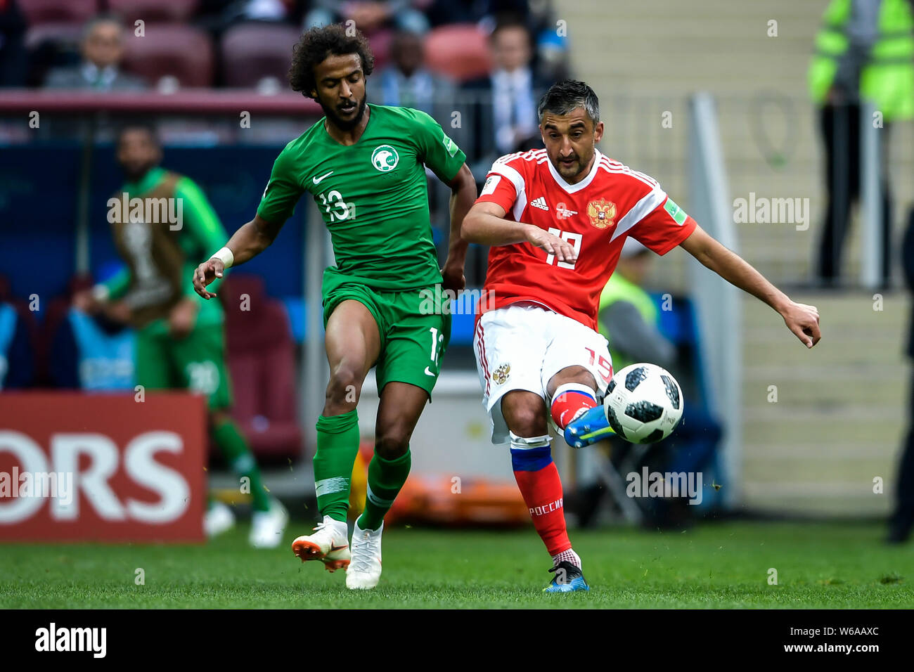 Aleksandr Samedov of Russia, right, challenges Yasser Al-Shahrani of Saudi Arabia in their Group A match during the 2018 FIFA World Cup in Moscow, Rus Stock Photo