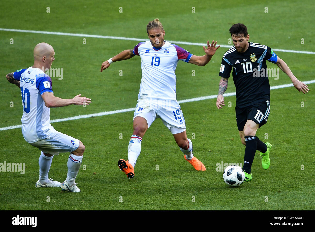 Lionel Messi of Argentina, right, challenges Rurik Gislason, center, and Emil Hallfredsson of Iceland in their Group D match during the FIFA World Cup Stock Photo