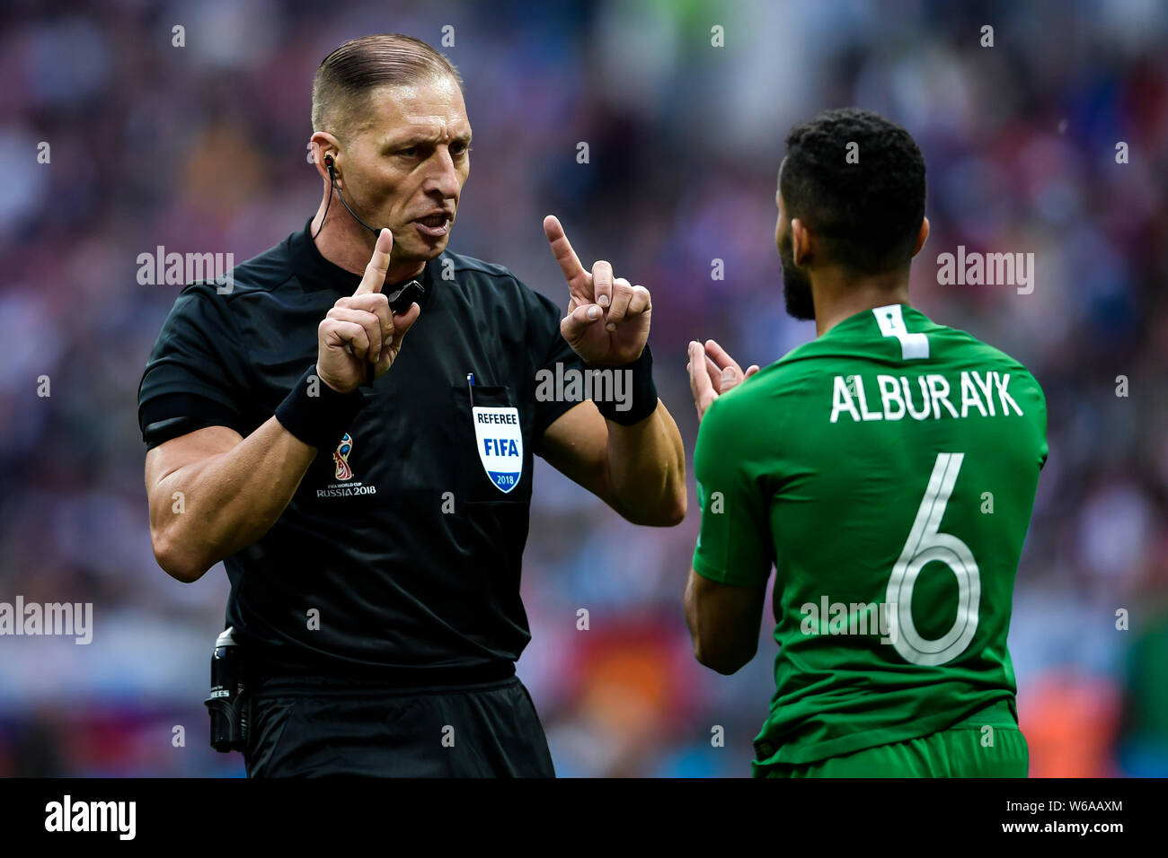 Referee Nestor Pitana talks with Mohammed Al-Breik of Saudi Arabia in their Group A match against Saudi Arabia during the 2018 FIFA World Cup in Mosco Stock Photo