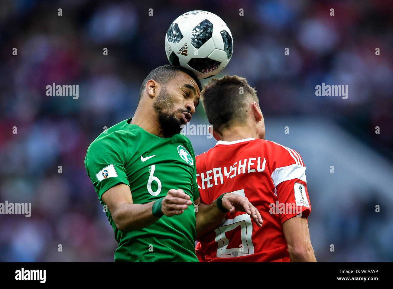 Denis Cheryshev of Russia, right, heads the ball against Mohammed Al-Breik of Saudi Arabia in their Group A match during the 2018 FIFA World Cup in Mo Stock Photo
