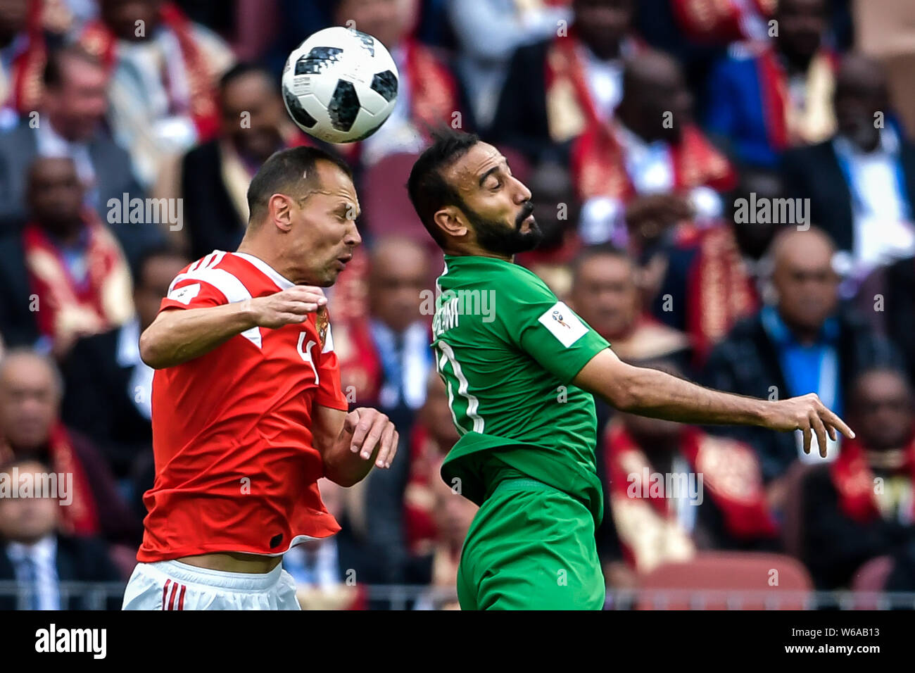A player of Russia, left, challenges Mohammad Al-Sahlawi of Saudi Arabia in their Group A match during the 2018 FIFA World Cup in Moscow, Russia, 14 J Stock Photo