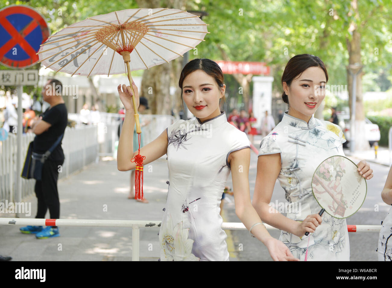Four Chinese women dressed in cheongsam, also known as qipao in Chinese, to  wish students "win victory in the first battle", pose in front of a middle  Stock Photo - Alamy