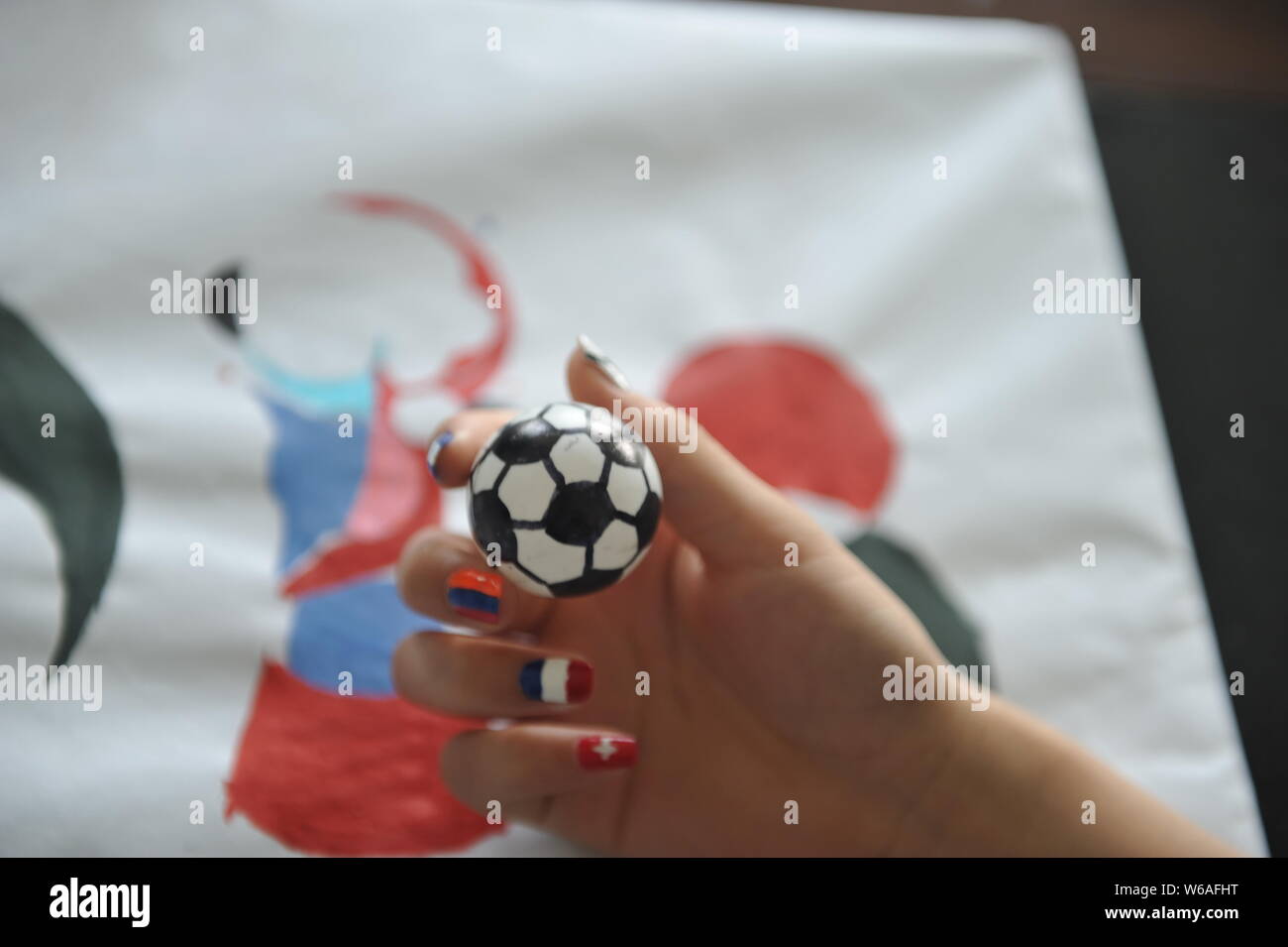 A female football fan shows her nail art design inspired by the 2018 FIFA World Cup in Liaocheng city, east China's Shandong province, 11 June 2018. Stock Photo