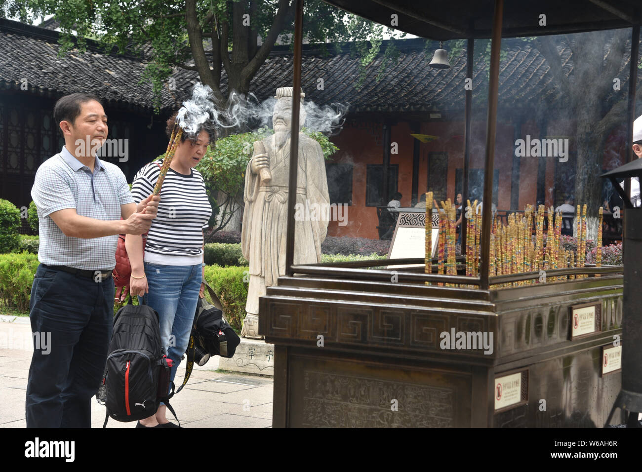 Chinese parents burn joss sticks (incenses) to pray their children for good luck in the upcoming national college entrance exam, also known as gaokao, Stock Photo