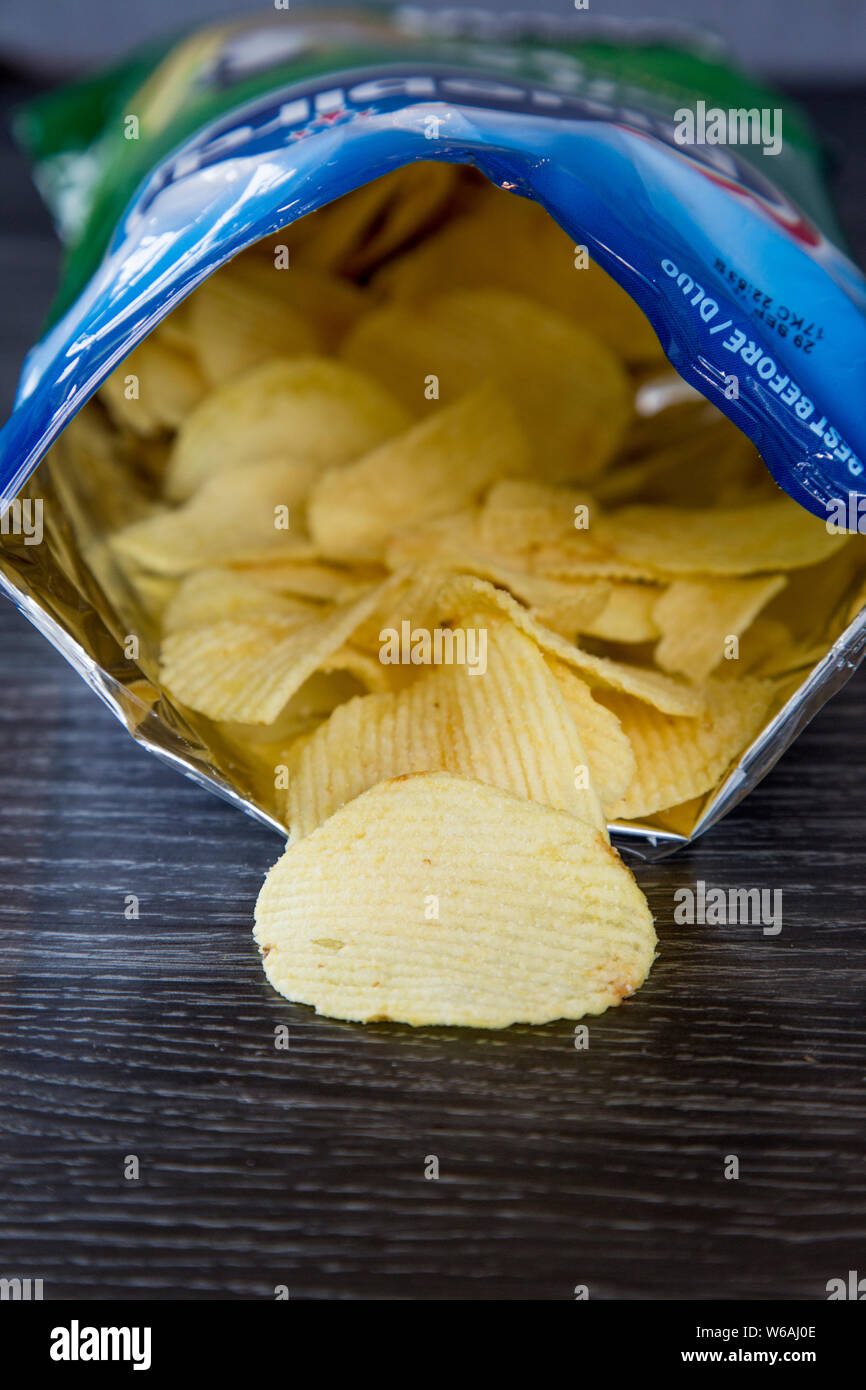 Packet of salt and vinegar chips made by Bluebird. Green and blue