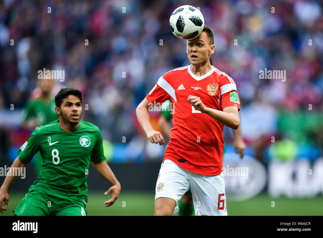 Denis Cheryshev of Russia, right, challenges Yahya Al-Shehri of Saudi Arabia in their Group A match during the 2018 FIFA World Cup in Moscow, Russia, Stock Photo