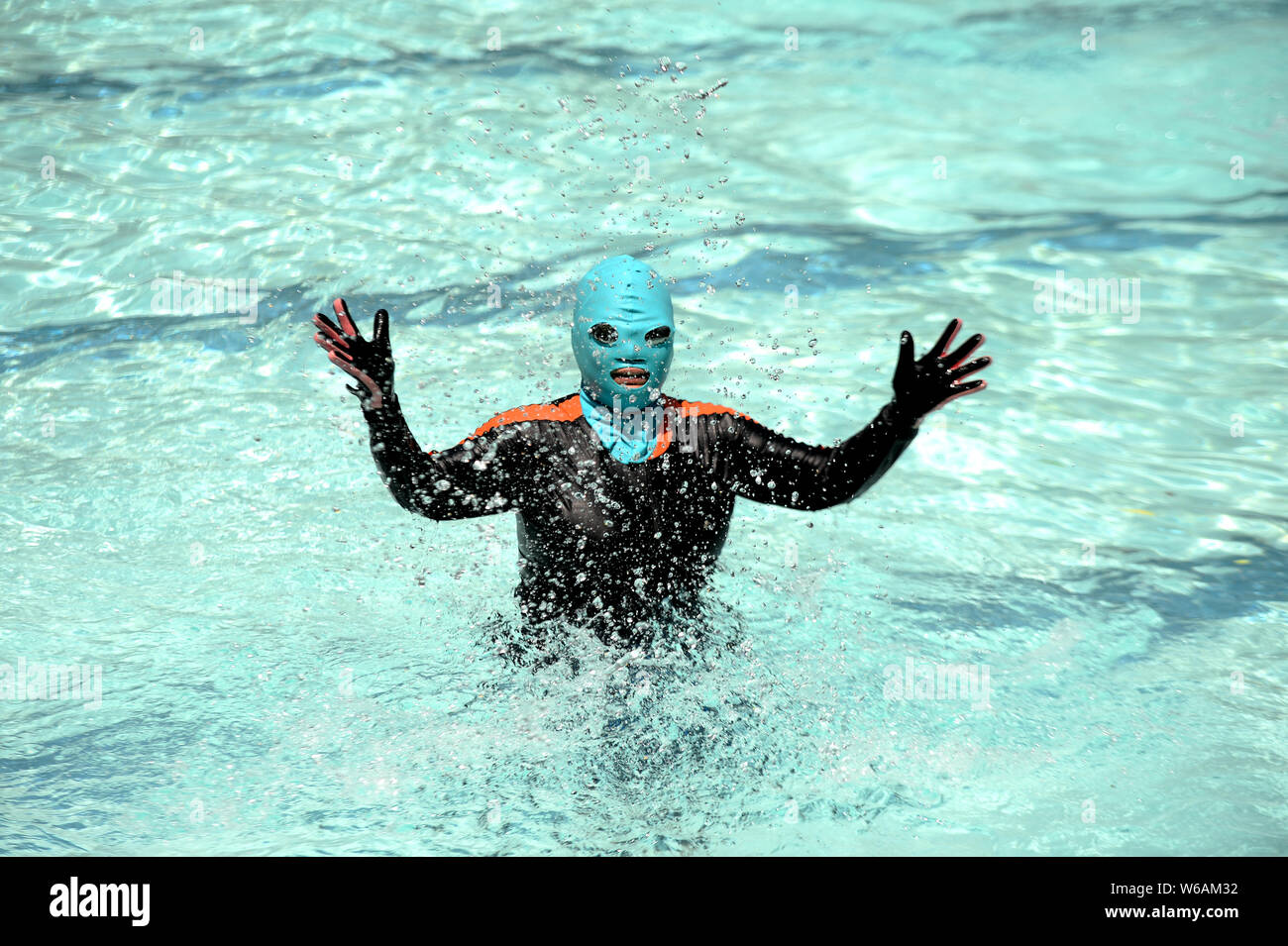A Chinese beachgoer wearing a facekini is pictured at a beach resort in
