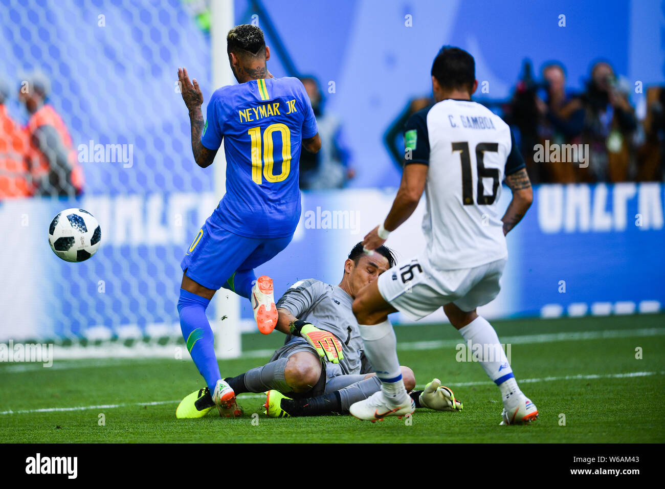 Neymar, left, of Brazil shoots to score a goal against Keylor Navas and Cristian Gamboa of Costa Rica in their Group E match during the FIFA World Cup Stock Photo