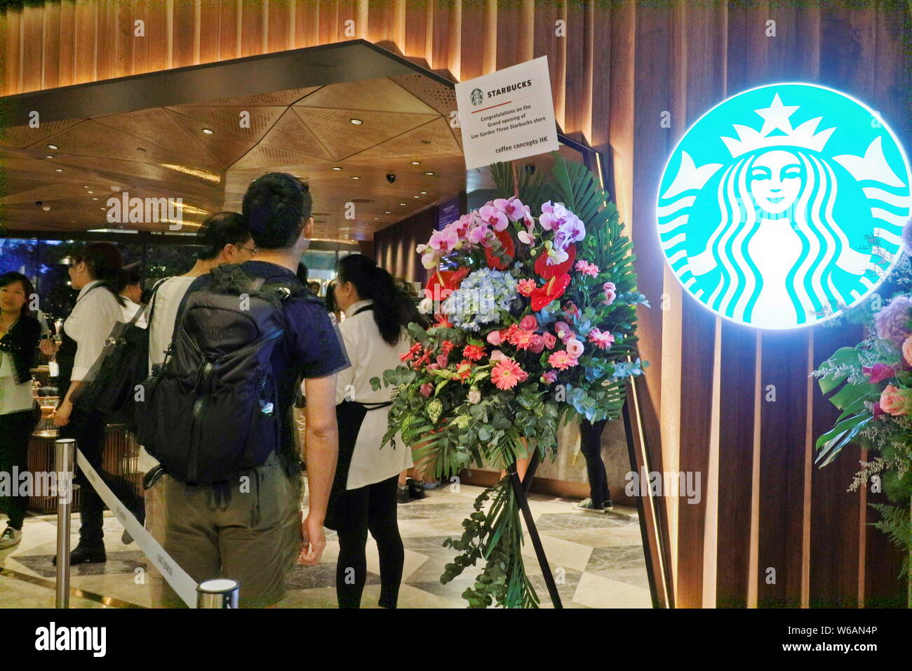 Customers queue up in front of Hong Kong's largest Starbucks flagship store at Causeway Bay in