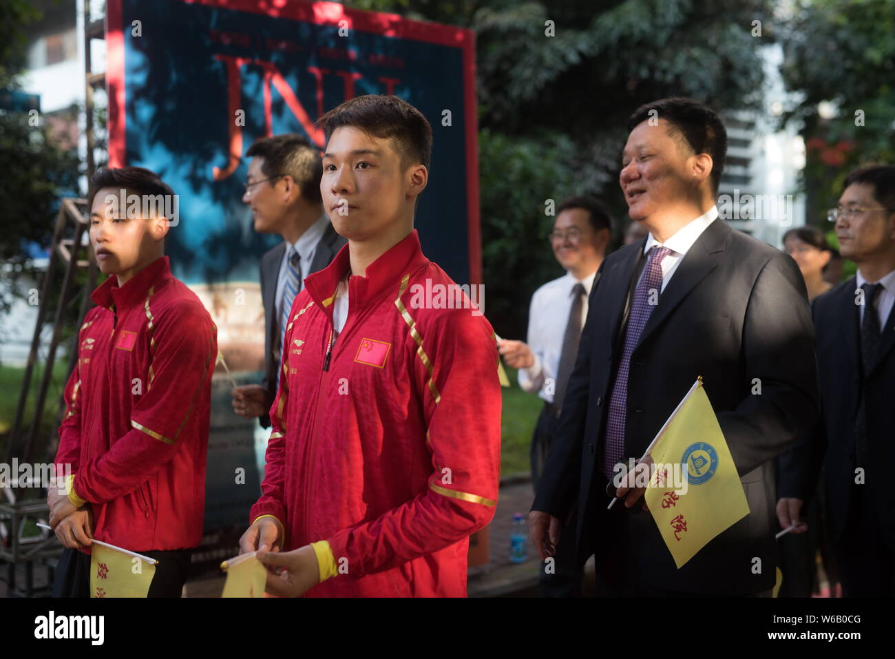 Chinese diving champions Chen Aisen and Xie Siyi, both of whom are graduates, walk on the red carpet for a graduation ceremony held by Jinan Universit Stock Photo