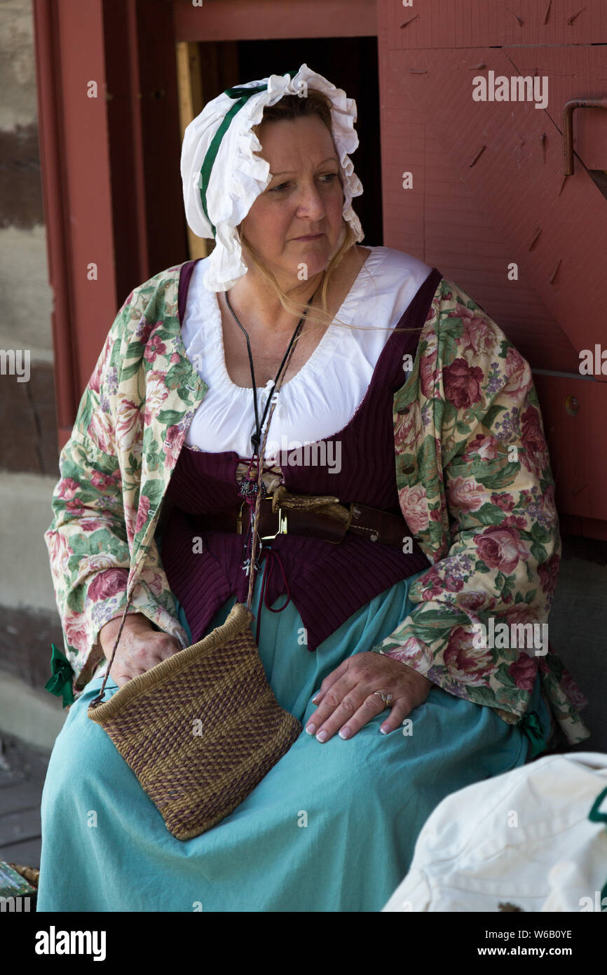 A reenactress in period clothing portrays an 18th century woman during an event at Historic Old Fort Wayne in Fort Wayne, Indiana, USA. Stock Photo