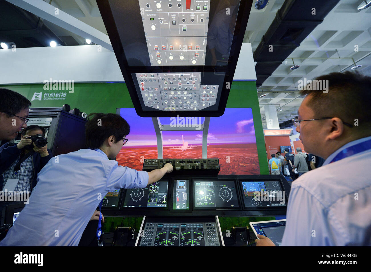 Exhibitors demonstrate in a model of civil aircraft cockpit during the 21st China Beijing International High-Tech Expo (CHITEC) in Beijing, China, 17 Stock Photo