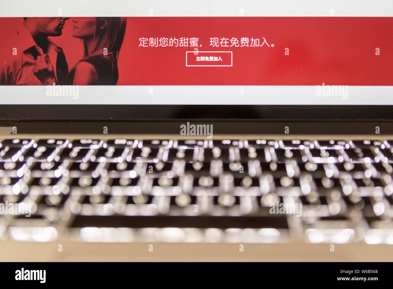 A Chinese netizen browses the dating website SeekingArrangement (SA) for people seeking "sugar daddies" or "sugar babies" on his computer in Beijing, Stock Photo