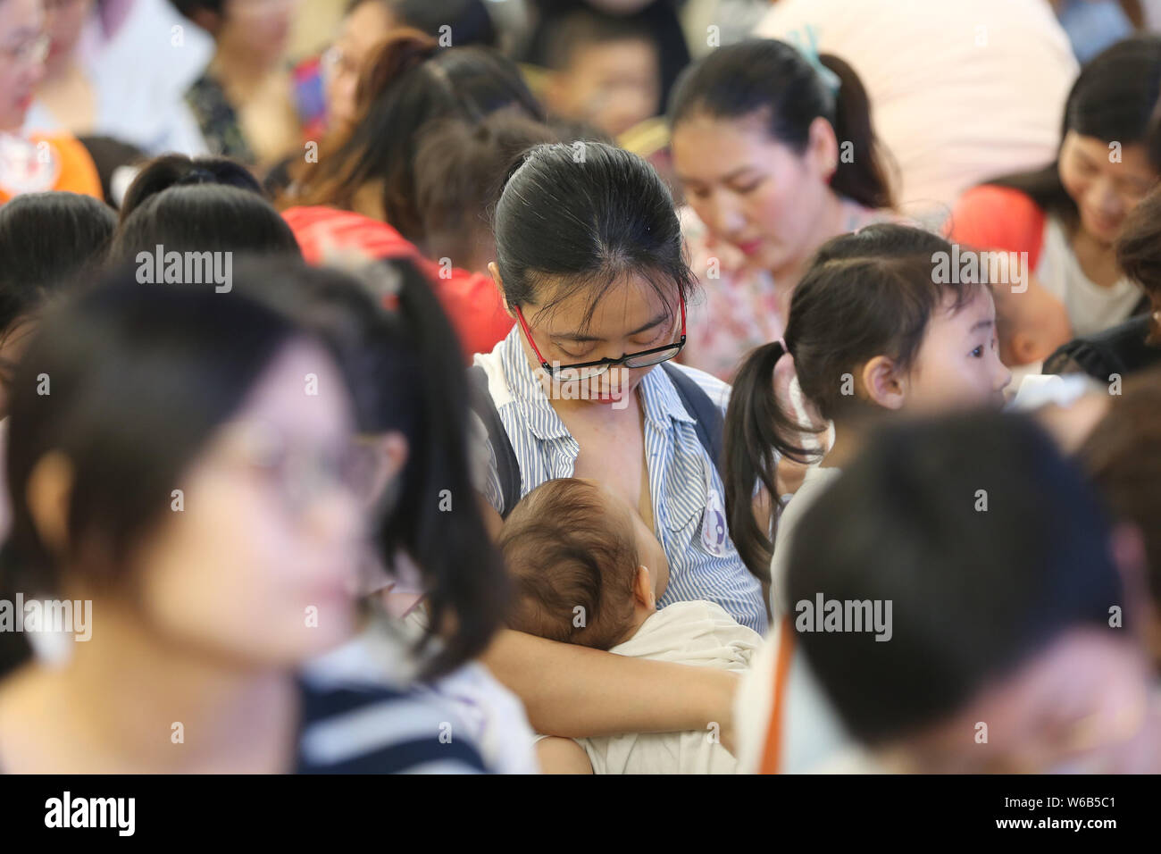 Chinese mothers attend an event to promote breastfeeding on the