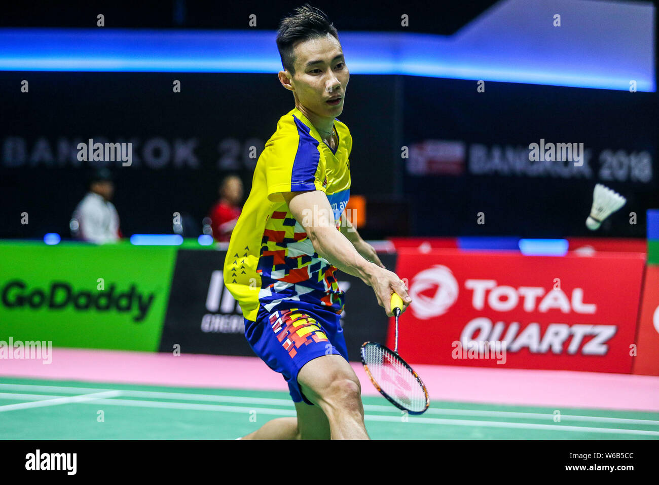 Lee Chong Wei of Malaysia returns a shot to Vladimir Malkov of 