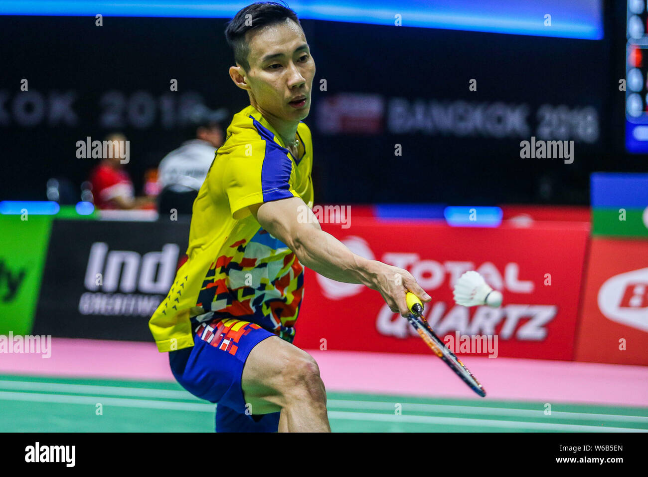 Lee Chong Wei of Malaysia returns a shot to Vladimir Malkov of 