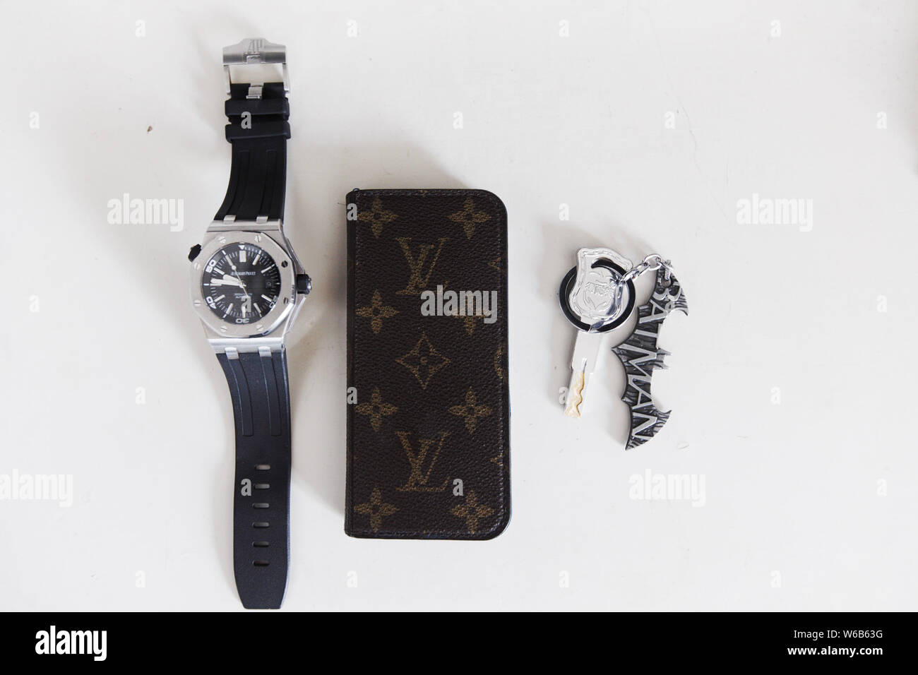 27-year-old Chinese appraiser Yan Chuang shows his Audemars Piguet watch, LV (Louis Vuitton) handbag, and key at his studio in Beijing, China, 9 May 2 Stock Photo