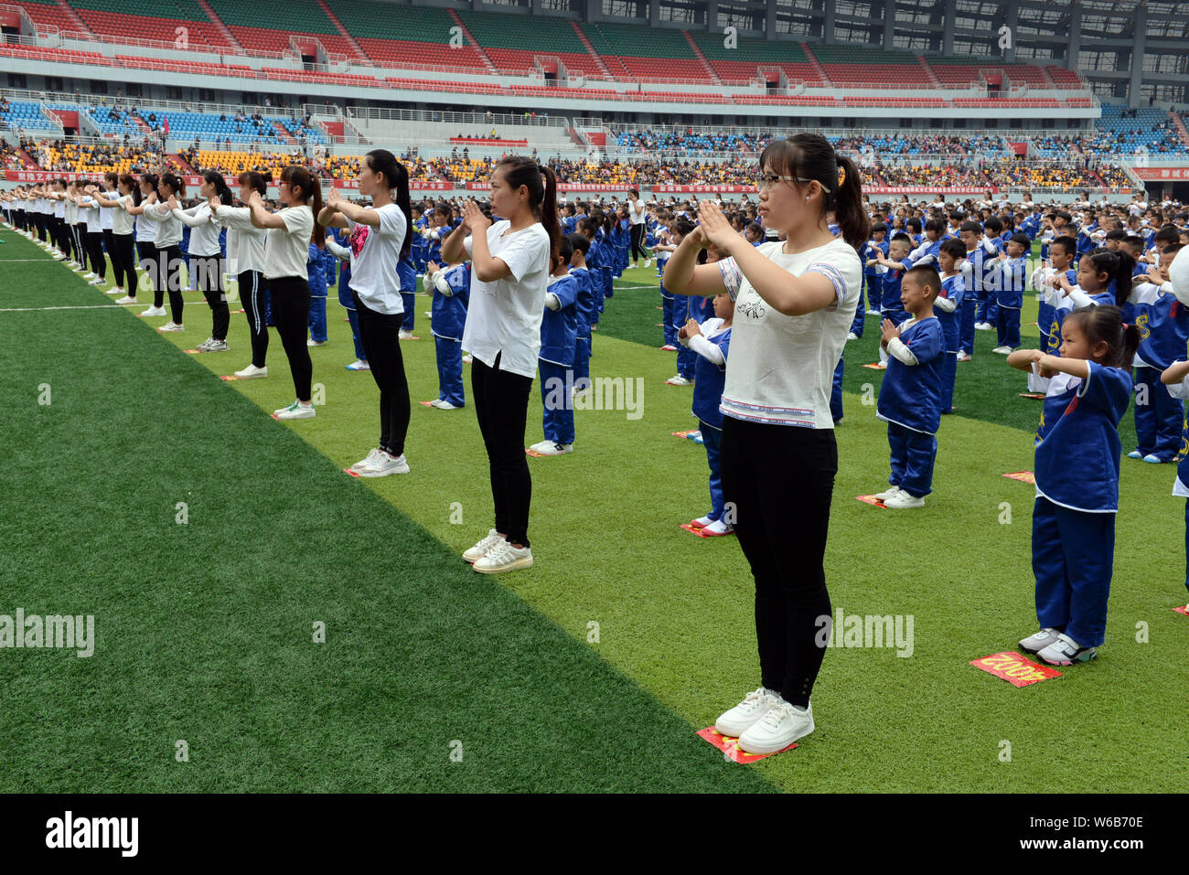 Chinese children perform kungfu with a master in an attempt to set a