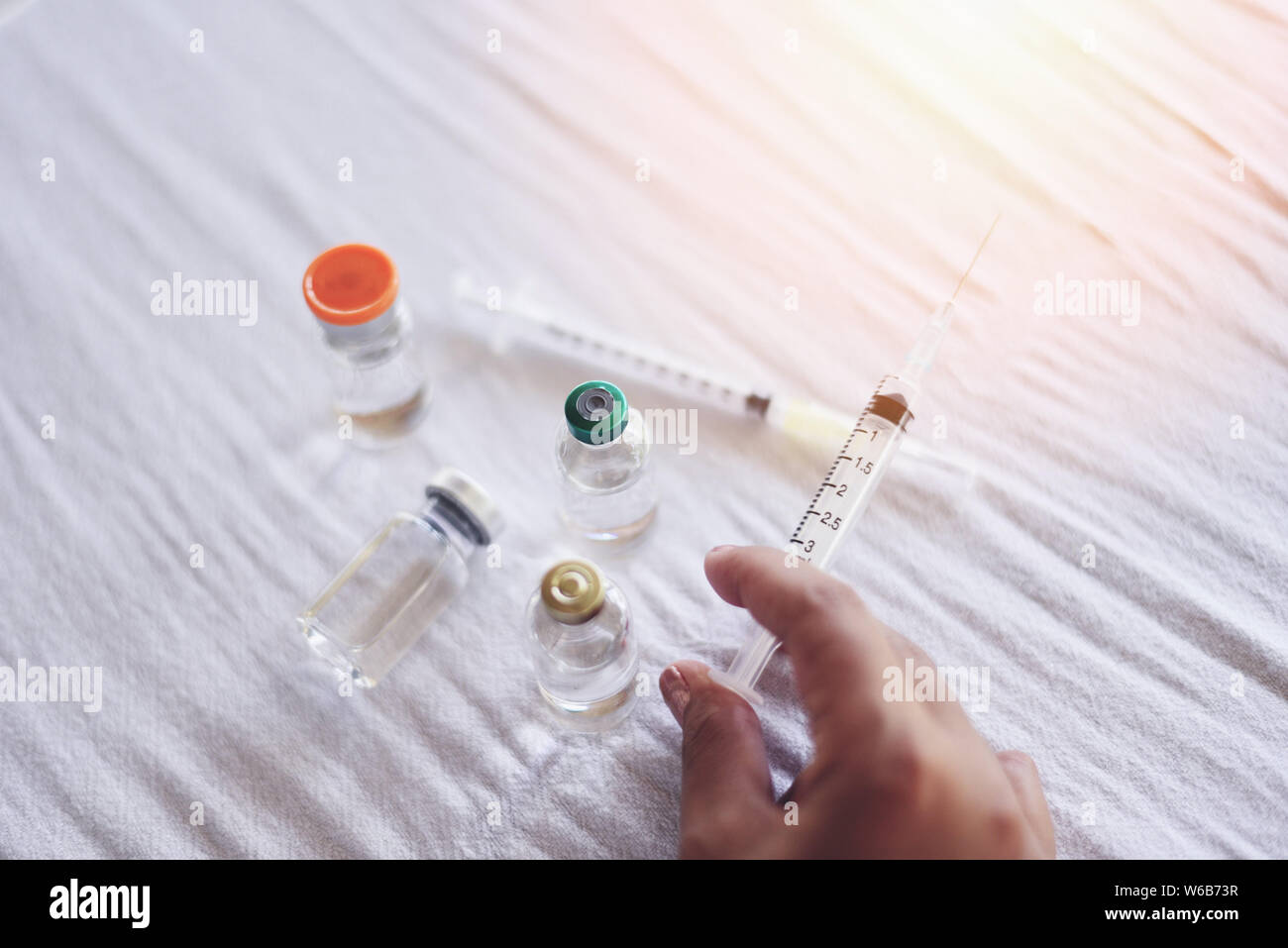 Syringe medication injection and needle in hand nurse asian for giving