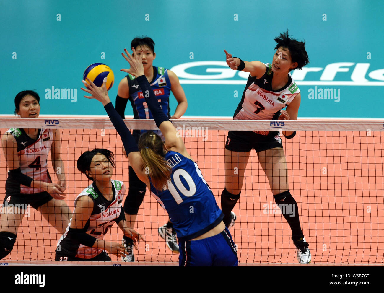 Yuki Ishii, top, of Japan spikes against Cristina Chirichella of Italy