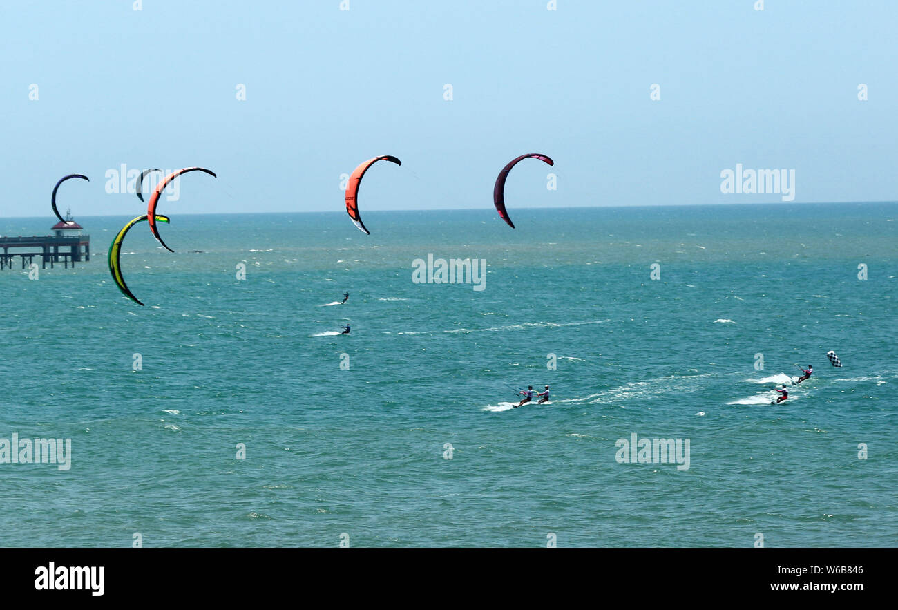 Kite surfers compete during the 2018 Boao International Kiteboarding Festival, also the qualification event of the 2018 Youth Olympic Games (YOG), in Stock Photo