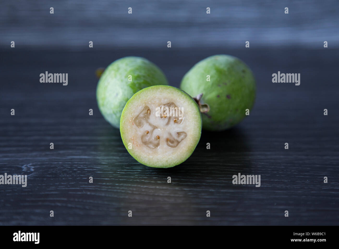 Homegrown organic feijoas. Whole fruit and cut fruit. Rough green skin