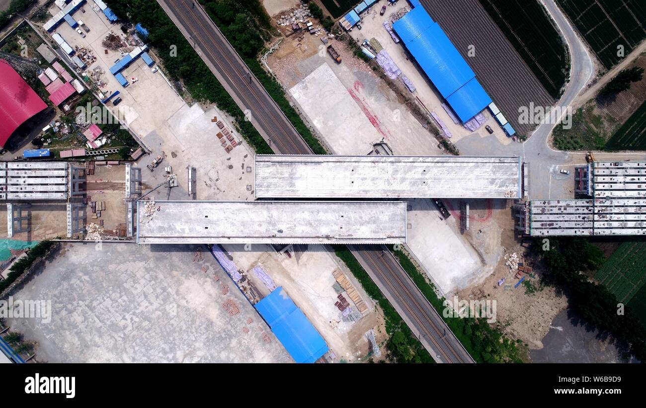 Two girder bridges weighing 10,400 tonnes are rotated 52.5 degrees anticlockwise over the Beijing-Harbin railway and form a flyover at the Yutian sect Stock Photo