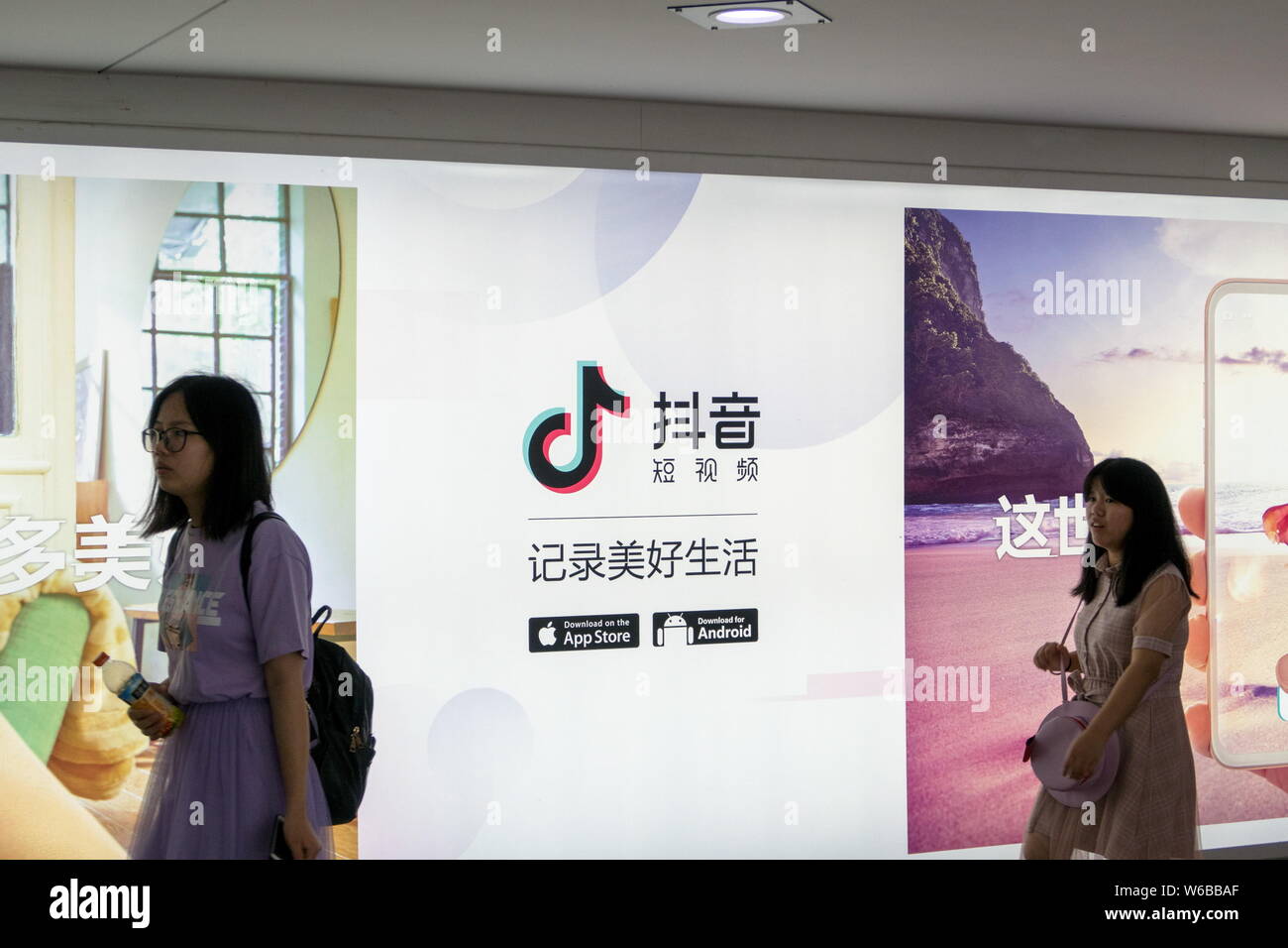 Pedestrians walk past an advertisement for the mobile app of Tik Tok, an overseas iteration of short video app Douyin, of Beijing Bytedance Technology Stock Photo