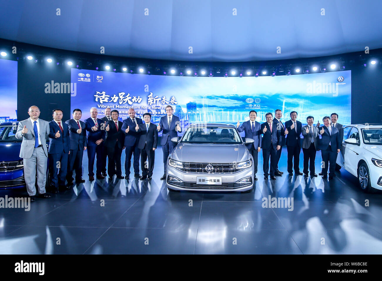 Jochem Heizmann, center left, Chief Executive Officer and President of Volkswagen Group China, Xu Liuping, center right, Chairman of FAW Group Corp., Stock Photo