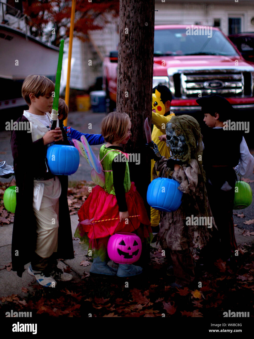 Young Children on Halloween Trick or Treat visit in New Hampshire USA Stock Photo