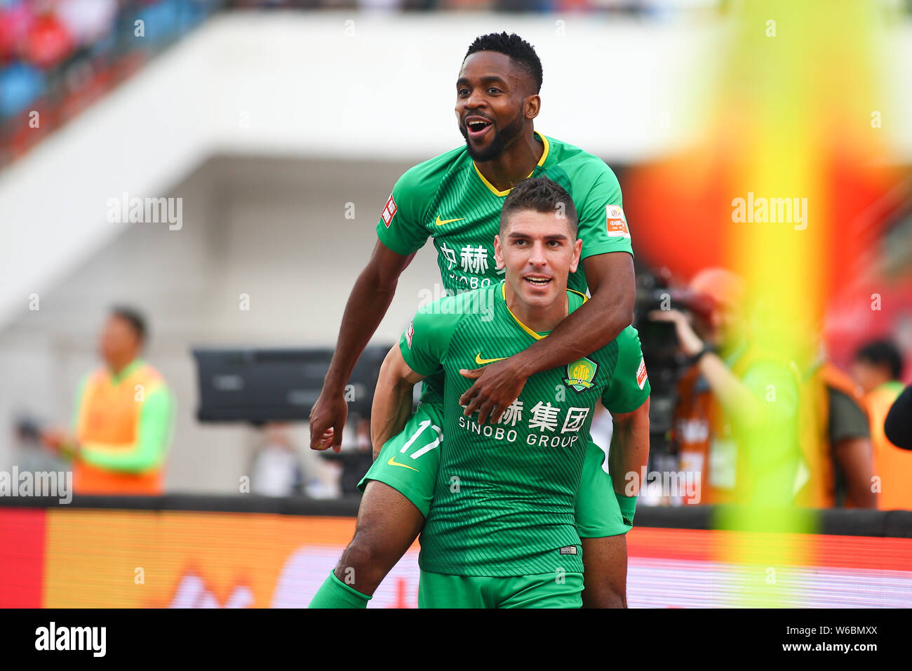 French-born Congolese football player Cedric Bakambu of Beijing Sinobo  Guoan, upper, celebrates with Spanish football player Jonathan Soriano  after sc Stock Photo - Alamy