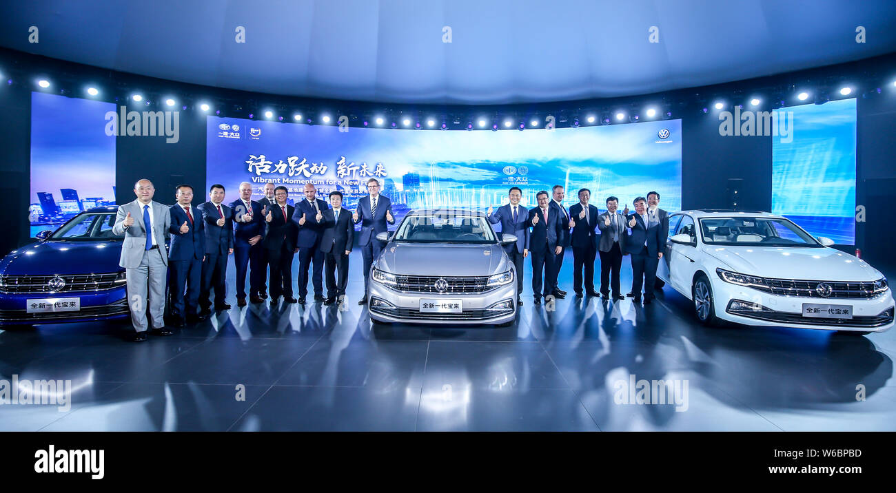 Jochem Heizmann, center left, Chief Executive Officer and President of Volkswagen Group China, Xu Liuping, center right, Chairman of FAW Group Corp., Stock Photo