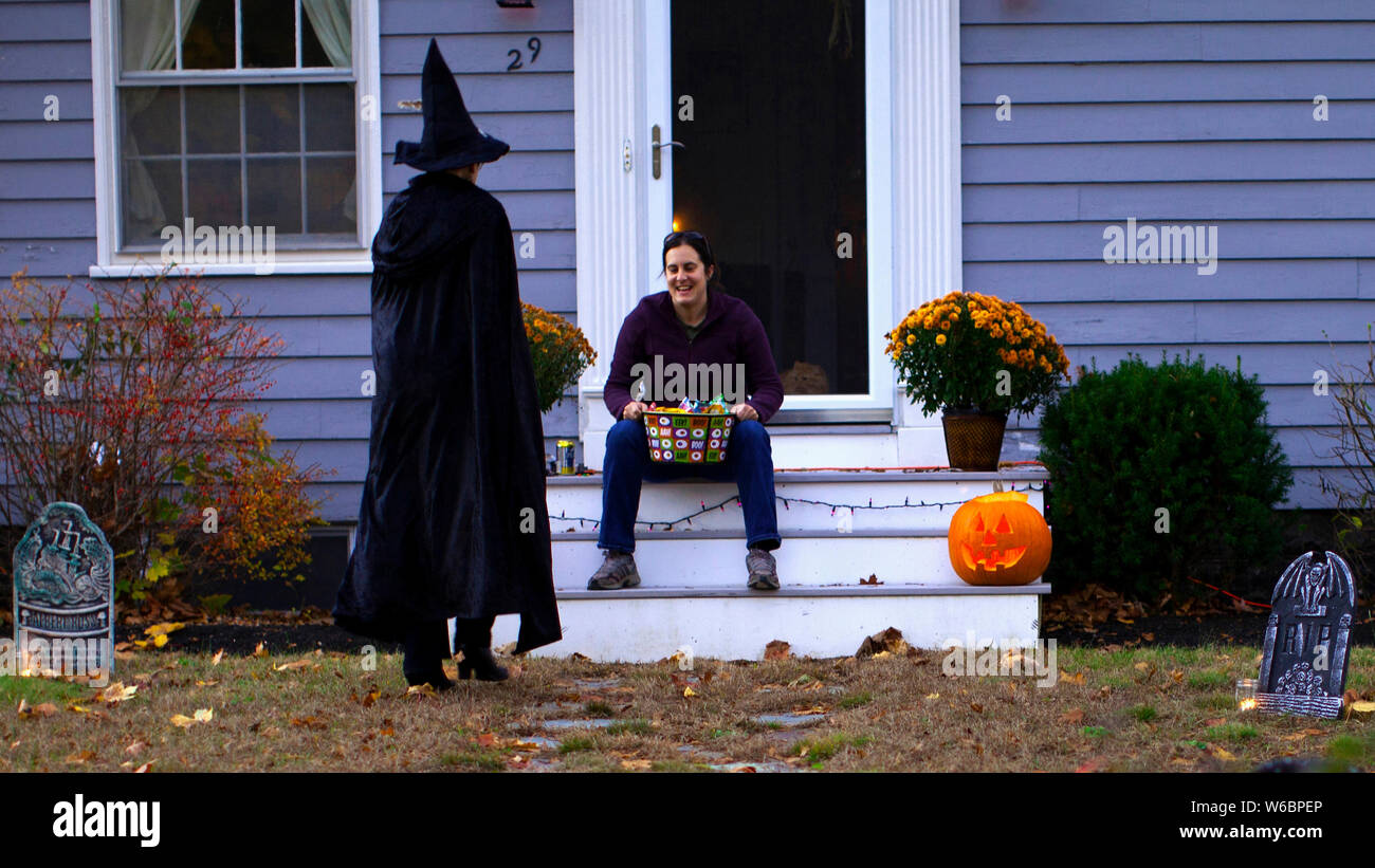 Witch casts a spell on  a woman, Trick or Treat night Stock Photo