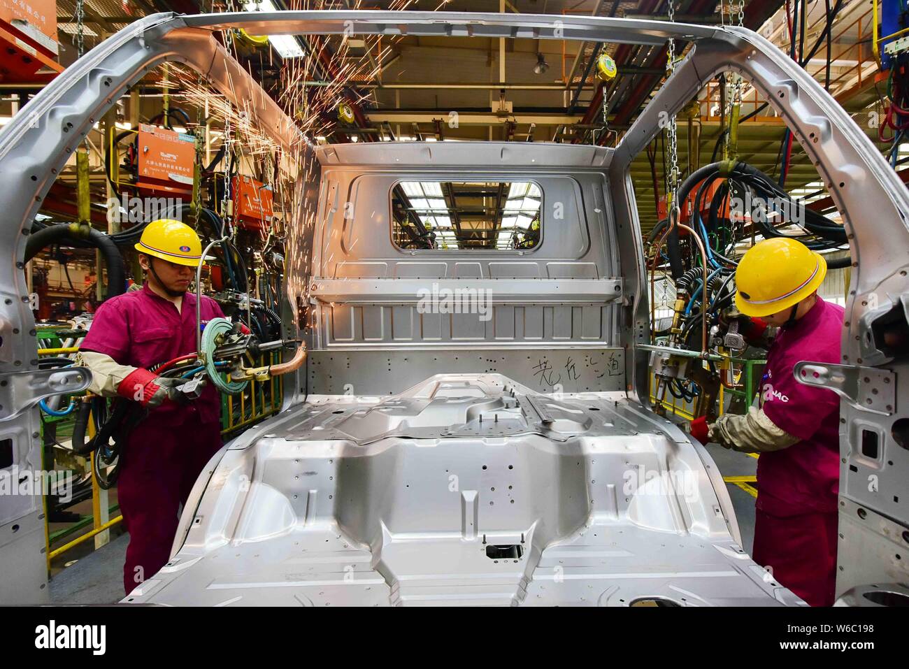--FILE--Chinese workers assemble a car on the assembly line at the auto ...