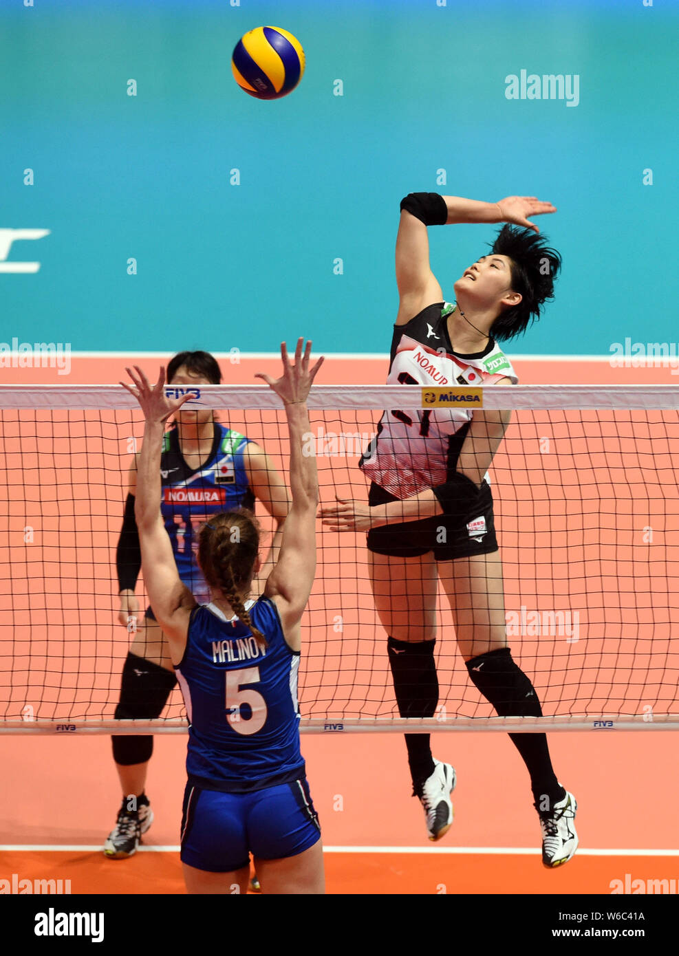 Ai Kurogo, top, of Japan spikes against Ofelia Malinov of Italy in