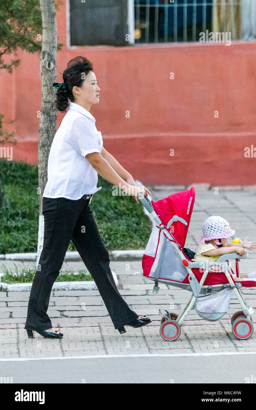 --FILE--A North Korean mother pushes her baby in the baby carriage on ...