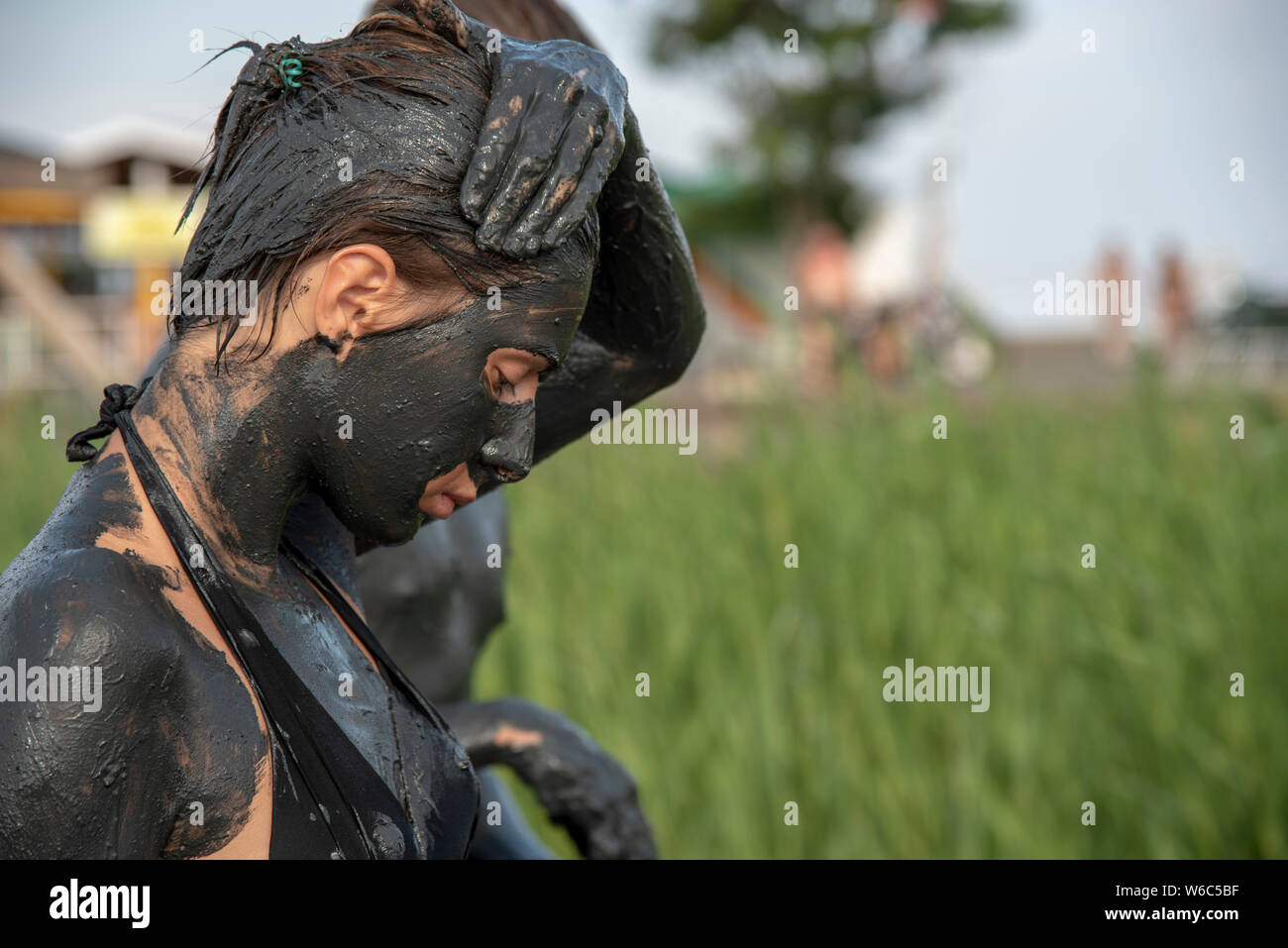 The girl, smeared with black healing mud, puts the dirt on her hair with her hand to strengthen the health of her hair and skin Stock Photo - Alamy The girl, smeared with black healing mud, puts the dirt on her hair with her hand to strengthen the health of her hair and skin Stock Photo - Alamy
