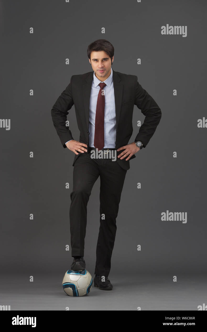 Businessman playing with soccer ball Stock Photo - Alamy