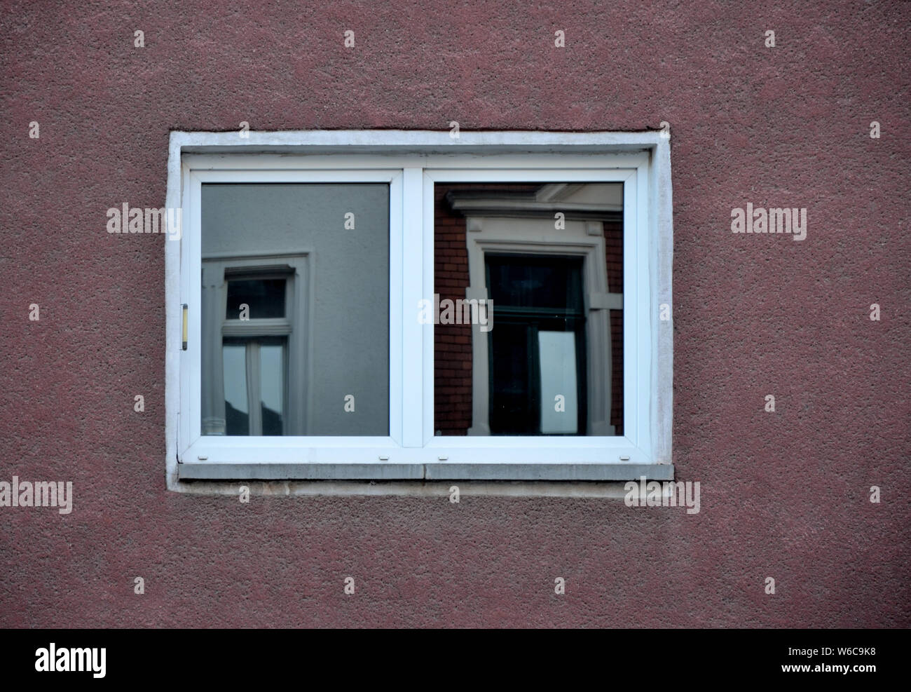 Window with reflection on an dark red wall Stock Photo