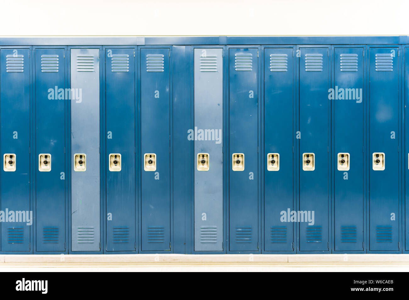 Worn down navy blue school lockers straight on Stock Photo