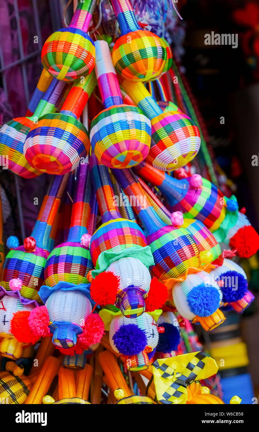 Colorful Blue Yellow Straw Toys Rattles Oaxaca Mexico.  Oaxaca has famous handicrafts Stock Photo